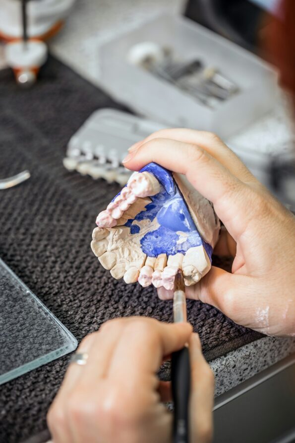 Dental technician applying ceramics