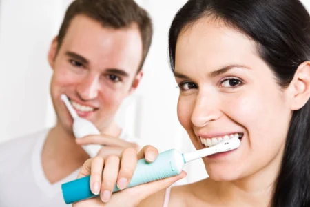 Wife and husband brushing teeth in home
